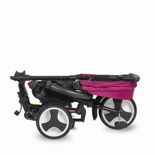 Zusammengeklappter Dreirad-Kinderwagen in Magenta und Schwarz, liegend, aus der Vogelperspektive.